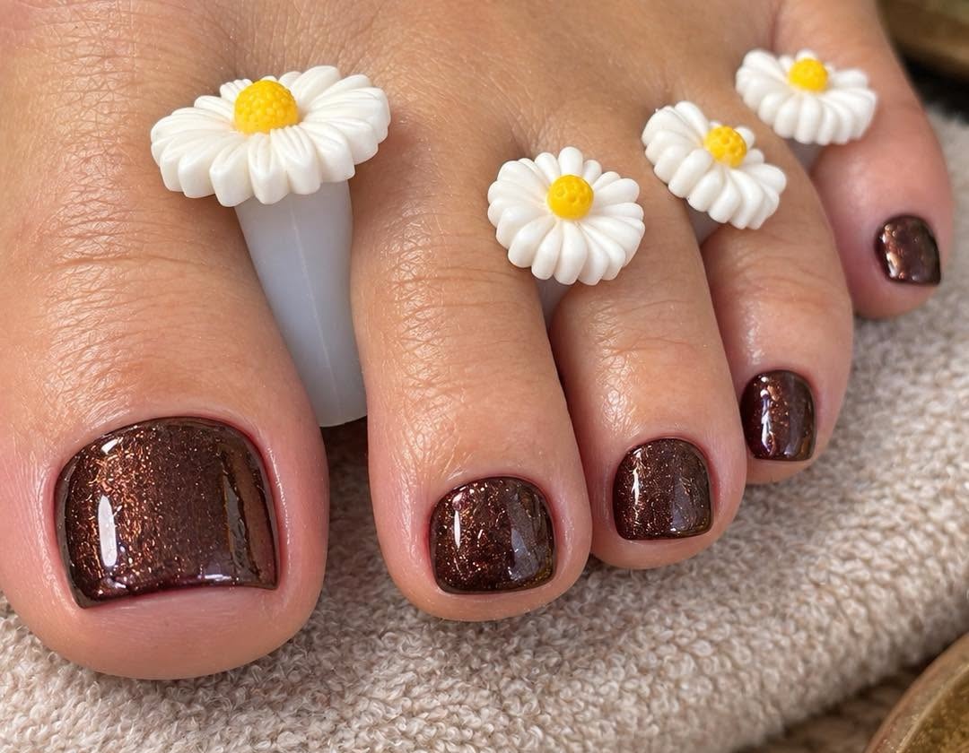 Glitter pedicure with daisy toe separators